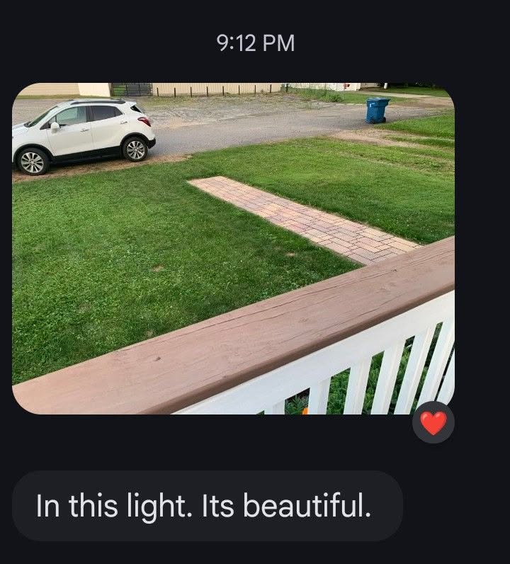 Customer view of a freshly cut front lawn beside a brick walk